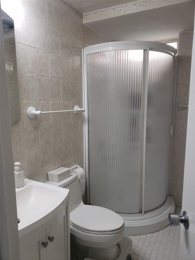 31 Stevenson Ave, Hartsdale, NY 10530 - bathroom with a stall shower, vanity, toilet, tile patterned floors, and tile walls