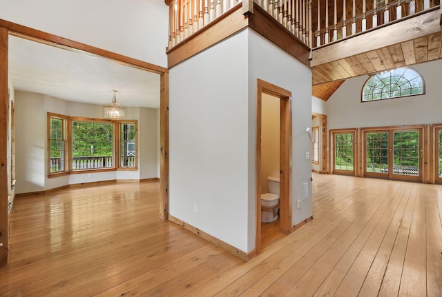 6843 Rte 55, Wingdale, NY 12594 - hallway featuring high vaulted ceiling, a chandelier, plenty of natural light, and light wood finished floors
