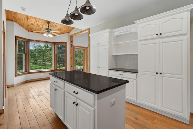 6843 Rte 55, Wingdale, NY 12594 - kitchen featuring open shelves, dark countertops, ceiling fan, light wood-type flooring, and a kitchen island