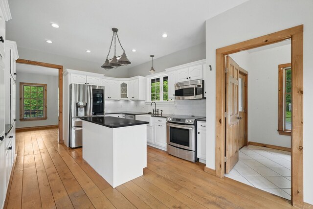 6843 Rte 55, Wingdale, NY 12594 - kitchen with stainless steel appliances, white cabinets, a center island, tasteful backsplash, and recessed lighting