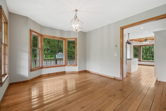 6843 Rte 55, Wingdale, NY 12594 - spare room with a chandelier, light wood-style floors, baseboards, and a ceiling fan