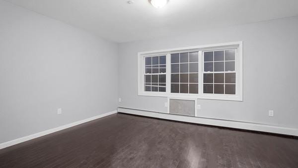 2040 Washington Ave, Bronx, NY 10457 - spare room featuring baseboards, wood finished floors, and baseboard heating