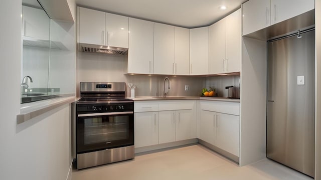 2040 Washington Ave, Bronx, NY 10457 - kitchen with stainless steel stove, under cabinet range hood, a sink, light countertops, and tasteful backsplash