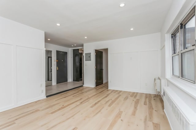 189 Drake Ave Unit 2A, New Rochelle, NY 10805 - unfurnished room with radiator, a decorative wall, light wood finished floors, and recessed lighting