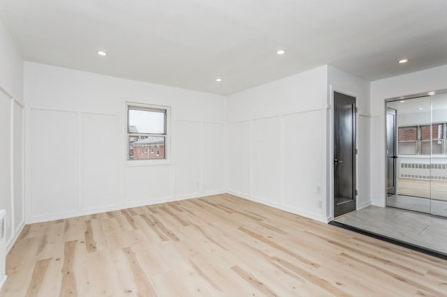 189 Drake Ave Unit 2A, New Rochelle, NY 10805 - unfurnished room featuring a decorative wall, wood finished floors, and recessed lighting