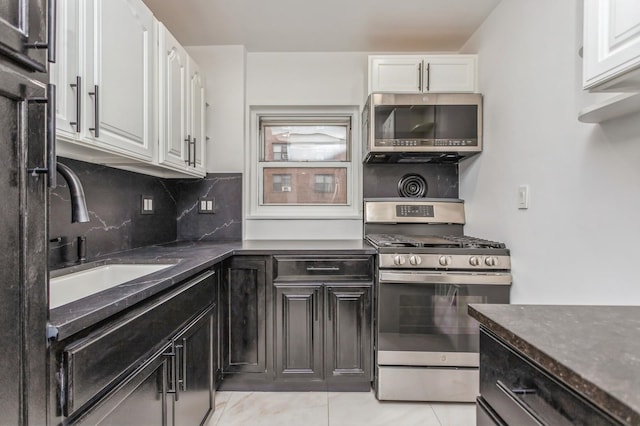 189 Drake Ave Unit 2A, New Rochelle, NY 10805 - kitchen with appliances with stainless steel finishes, white cabinetry, a sink, and backsplash
