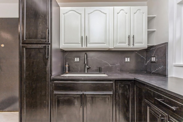 189 Drake Ave Unit 2A, New Rochelle, NY 10805 - kitchen featuring a sink, white cabinetry, dark brown cabinets, open shelves, and backsplash