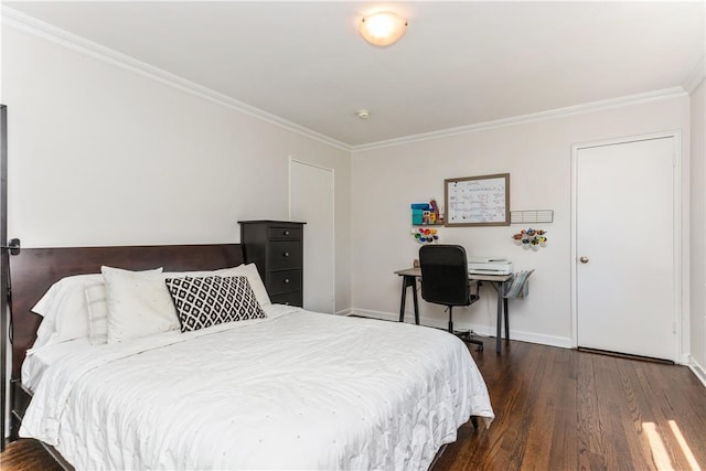bedroom with wood finished floors, crown molding, and baseboards