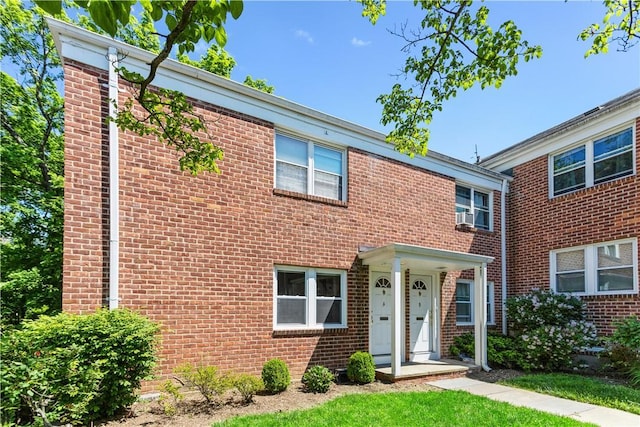 multi unit property with brick siding and cooling unit