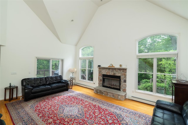 9 Golf Course Dr, Suffern, NY 10901 - living room featuring baseboard heating, high vaulted ceiling, a baseboard heating unit, wood finished floors, and a stone fireplace