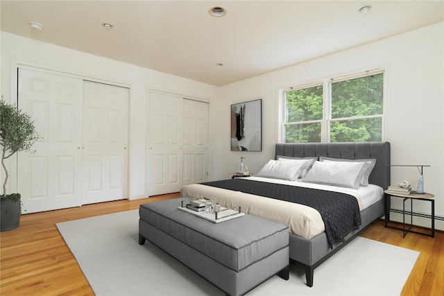 9 Golf Course Dr, Suffern, NY 10901 - bedroom featuring two closets, baseboard heating, and light wood-style flooring
