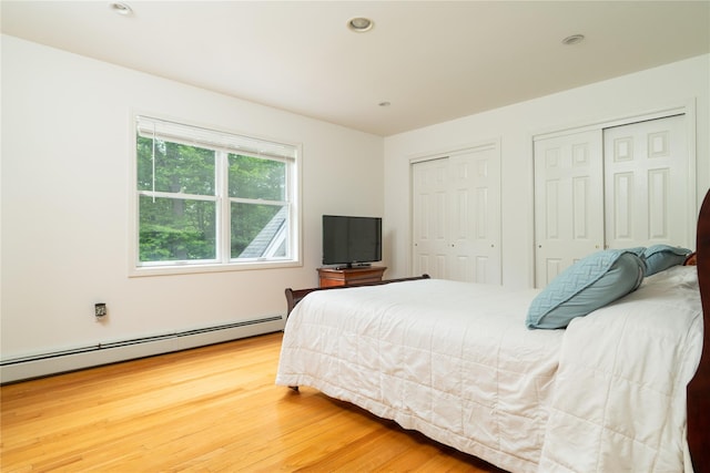 9 Golf Course Dr, Suffern, NY 10901 - bedroom featuring multiple closets, baseboard heating, wood finished floors, and recessed lighting