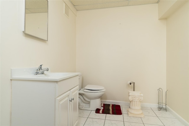 9 Golf Course Dr, Suffern, NY 10901 - half bath with vanity, toilet, baseboards, a paneled ceiling, and marble finish floors