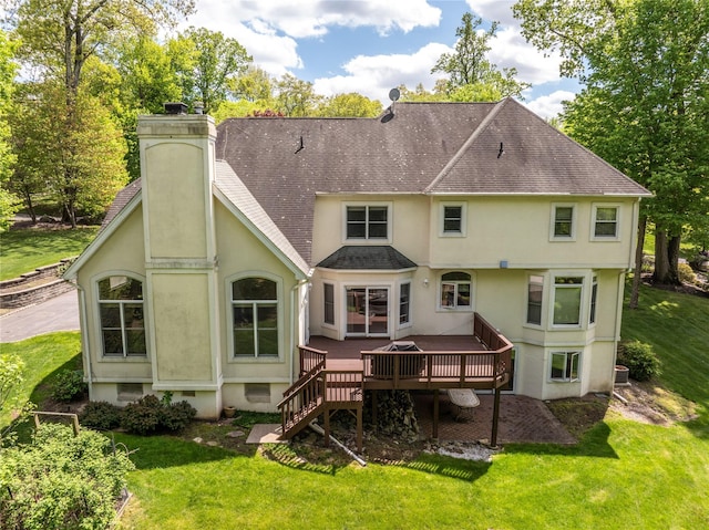 9 Golf Course Dr, Suffern, NY 10901 - rear view of house with a shingled roof, stucco siding, a wooden deck, and a lawn
