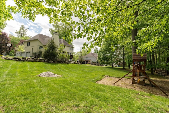 9 Golf Course Dr, Suffern, NY 10901 - view of grassy yard with a playground and an attached garage