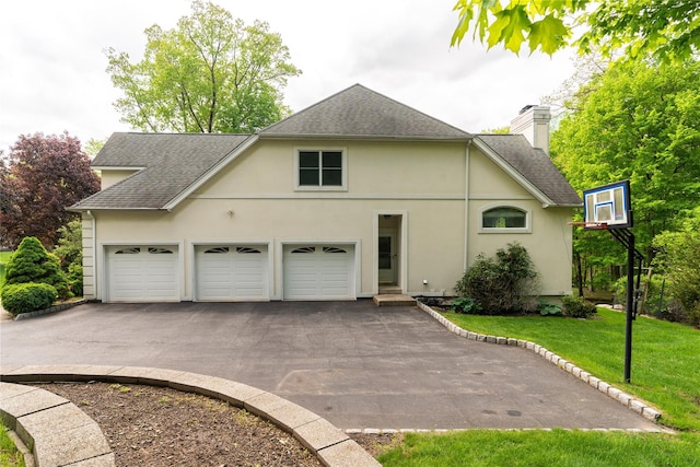 9 Golf Course Dr, Suffern, NY 10901 - view of home's exterior featuring driveway, a shingled roof, a chimney, and stucco siding