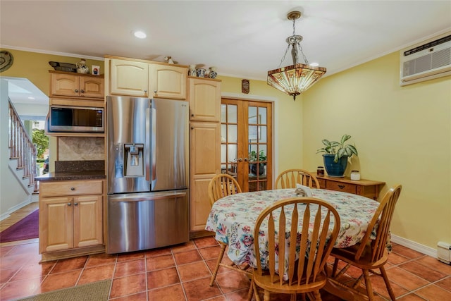 1784 W End Ave, New Hyde Park, NY 11040 - kitchen with appliances with stainless steel finishes, a wall unit AC, french doors, dark countertops, and ornamental molding