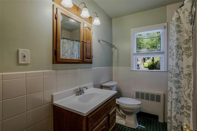 1784 W End Ave, New Hyde Park, NY 11040 - bathroom featuring radiator heating unit, tile walls, vanity, toilet, and tile patterned flooring