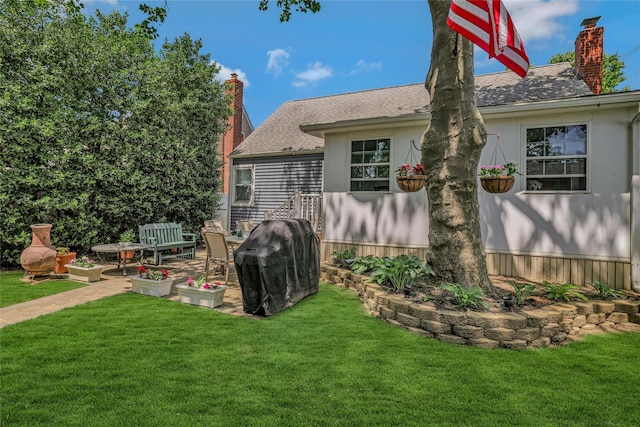 1784 W End Ave, New Hyde Park, NY 11040 - back of house with a chimney, a lawn, and roof with shingles