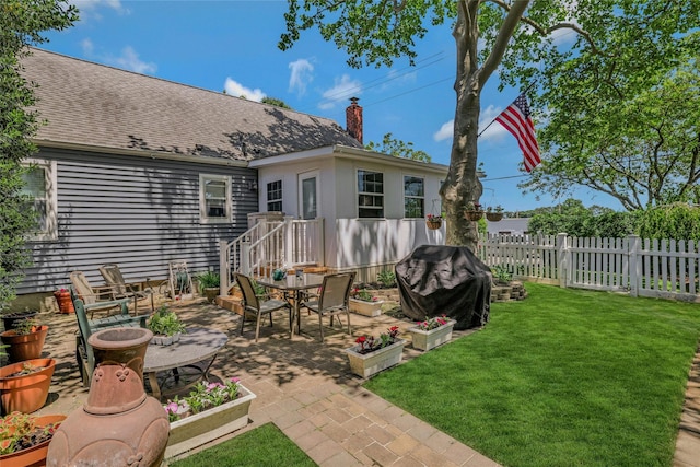 1784 W End Ave, New Hyde Park, NY 11040 - rear view of property with a patio area, a chimney, outdoor dining space, and roof with shingles