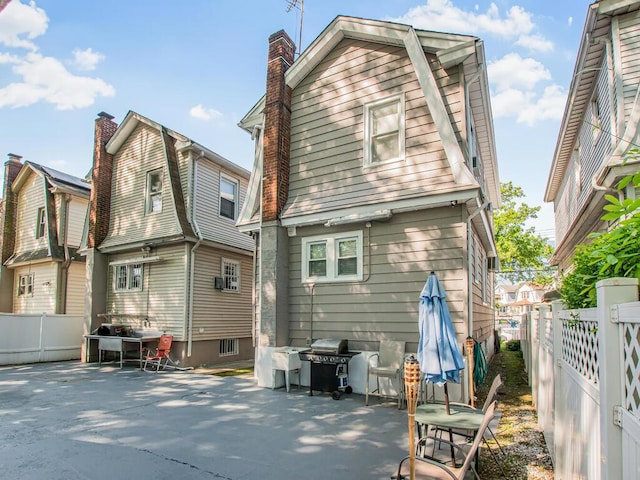 4428 Bruner Ave, Bronx, NY 10466 - rear view of property with a chimney, a fenced backyard, and a patio