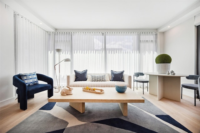 sitting room with light wood-type flooring and baseboards