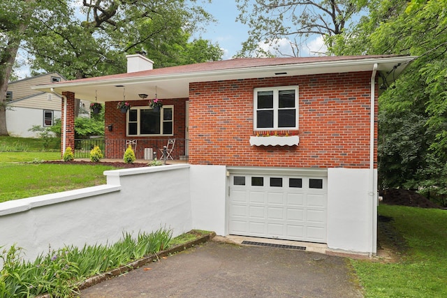 20 Ravensdale Rd, Hastings-On-Hudson, NY 10706 - view of front facade featuring asphalt driveway, a chimney, a garage, and brick siding