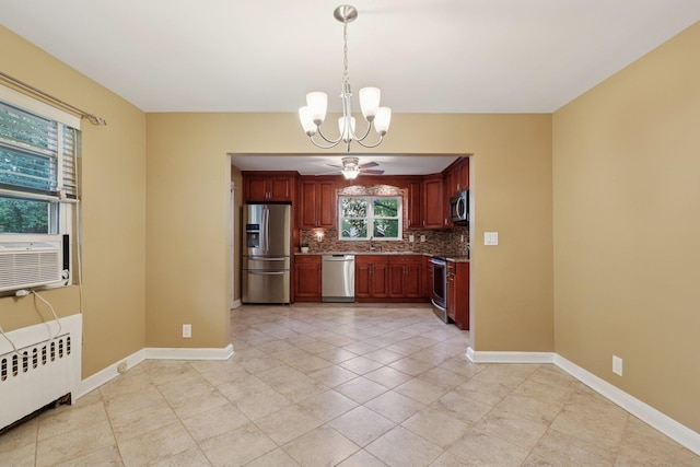 20 Ravensdale Rd, Hastings-On-Hudson, NY 10706 - kitchen with appliances with stainless steel finishes, radiator heating unit, a chandelier, tasteful backsplash, and pendant lighting