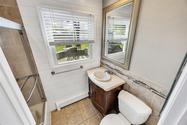 30 Twisting Dr, Lake Grove, NY 11755 - full bathroom with baseboard heating, toilet, a tile shower, vanity, and tile walls