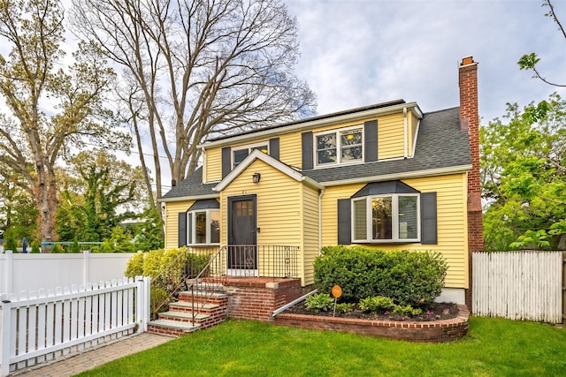 21 Livingston St, Deer Park, NY 11729 - view of front of house with a chimney and a shingled roof