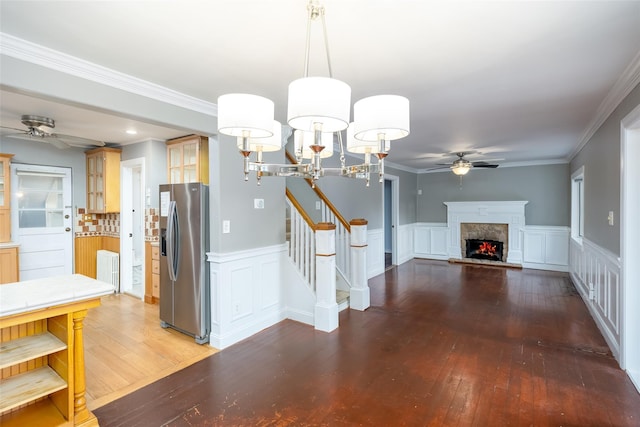 21 Livingston St, Deer Park, NY 11729 - unfurnished dining area featuring ceiling fan, light wood-type flooring, stairs, a premium fireplace, and a wainscoted wall