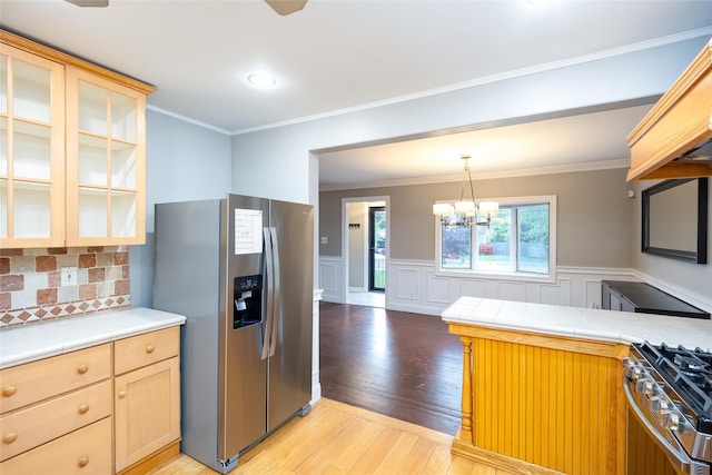 21 Livingston St, Deer Park, NY 11729 - kitchen featuring appliances with stainless steel finishes, light wood-type flooring, glass insert cabinets, tile counters, and a wainscoted wall