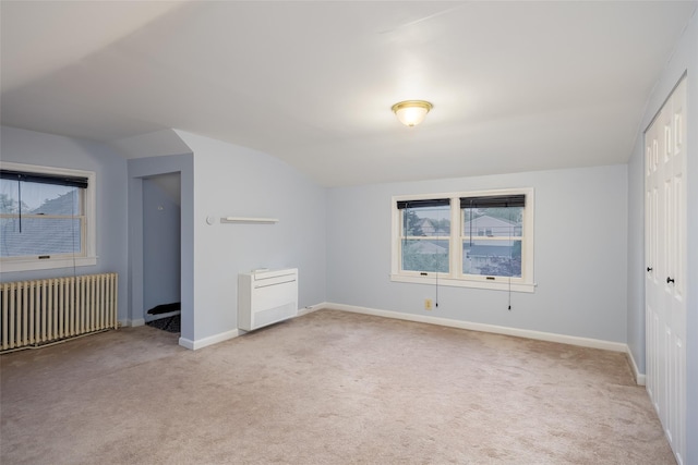 21 Livingston St, Deer Park, NY 11729 - unfurnished bedroom with radiator, lofted ceiling, light carpet, and baseboards
