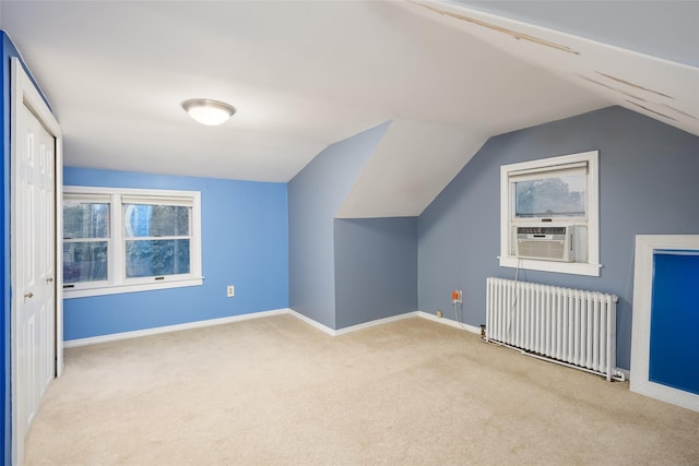 21 Livingston St, Deer Park, NY 11729 - additional living space with radiator heating unit, carpet flooring, lofted ceiling, cooling unit, and healthy amount of natural light