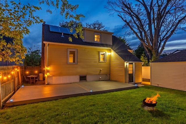 21 Livingston St, Deer Park, NY 11729 - back of property featuring a fire pit, a chimney, a wooden deck, and a shingled roof