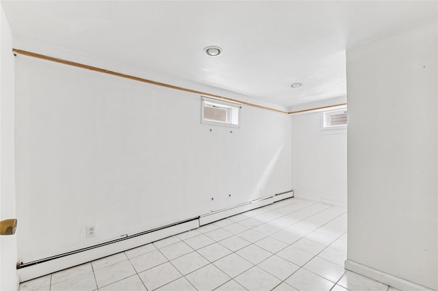basement featuring baseboard heating and baseboards