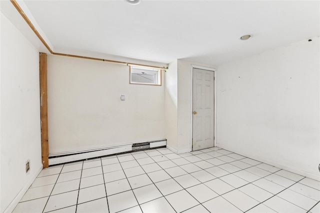 empty room with a baseboard heating unit and baseboards