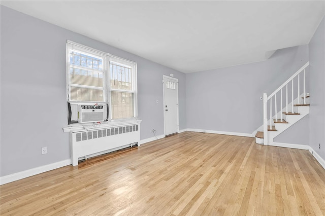 1141 E 213th St, Bronx, NY 10469 - entrance foyer featuring radiator, hardwood / wood-style floors, stairway, baseboards, and cooling unit