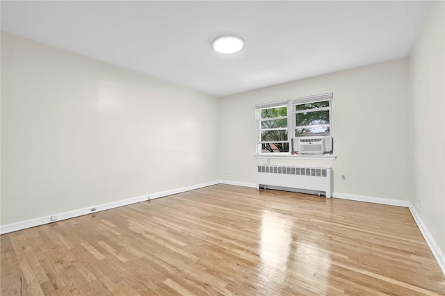 1141 E 213th St, Bronx, NY 10469 - spare room with radiator, wood finished floors, cooling unit, and baseboards