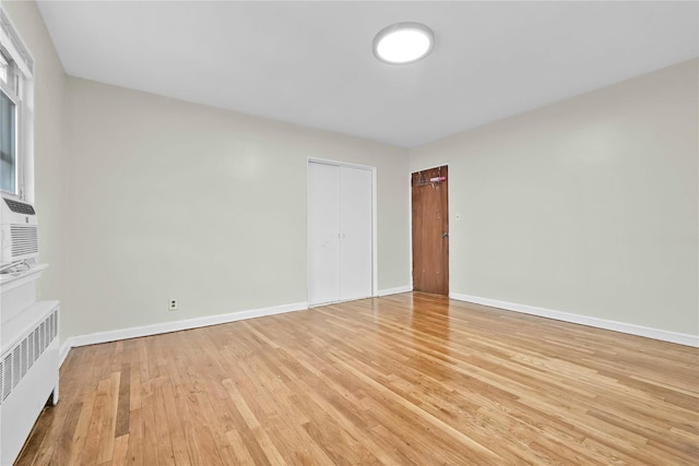 1141 E 213th St, Bronx, NY 10469 - unfurnished living room with light wood-style flooring, baseboards, and radiator
