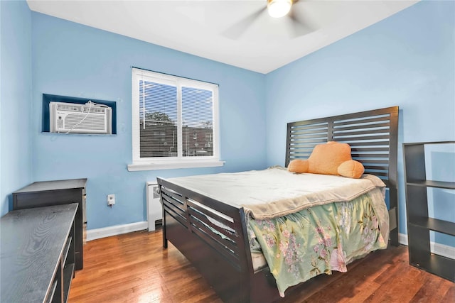 1141 E 213th St, Bronx, NY 10469 - bedroom featuring an AC wall unit, wood finished floors, baseboards, and ceiling fan