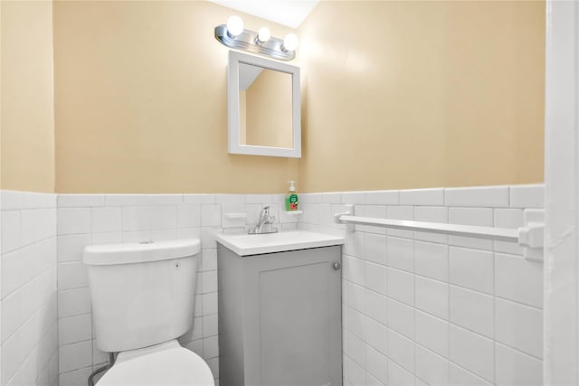 1141 E 213th St, Bronx, NY 10469 - bathroom with tile walls, a wainscoted wall, vanity, and toilet