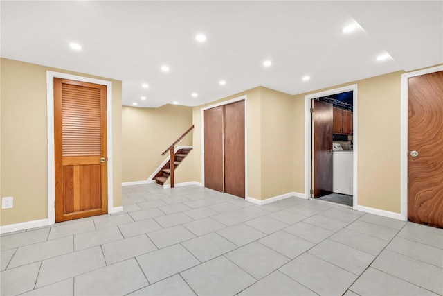 1141 E 213th St, Bronx, NY 10469 - spare room with washer / dryer, recessed lighting, stairway, baseboards, and light tile patterned floors