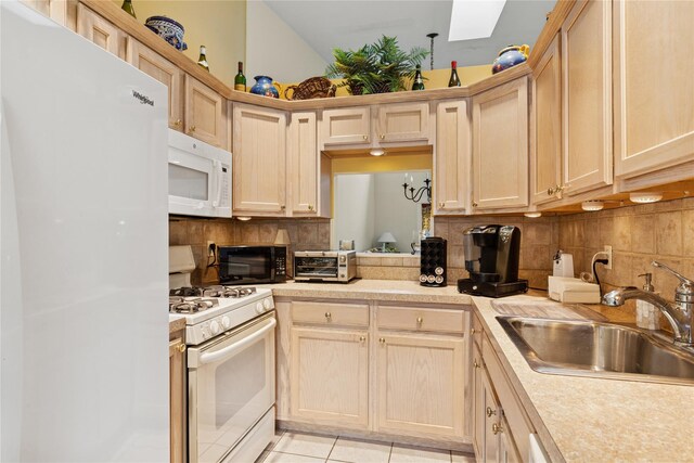 552 Birchwood Park Dr, Middle Island, NY 11953 - kitchen with white appliances, a sink, a skylight, light countertops, and tasteful backsplash