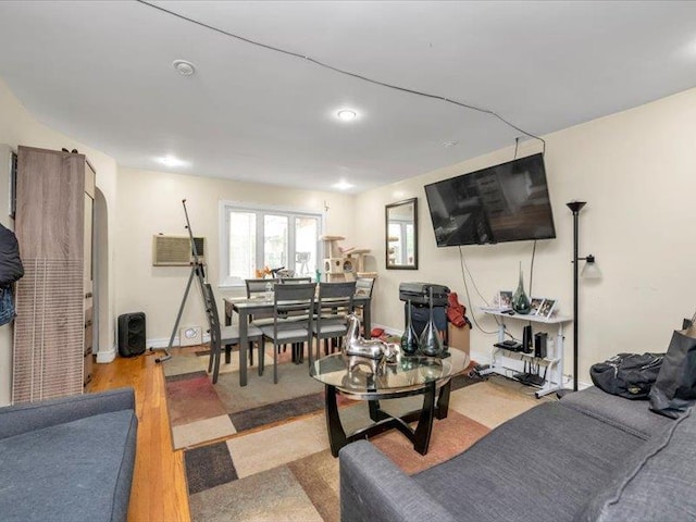150-31 78th Ave, Flushing, NY 11367 - living area featuring wood finished floors, recessed lighting, a wall mounted AC, and baseboards