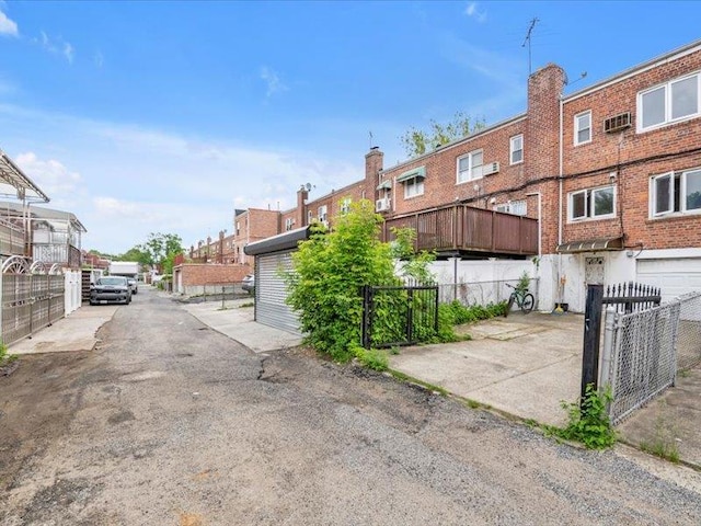 150-31 78th Ave, Flushing, NY 11367 - view of asphalt road featuring a gate and a residential view