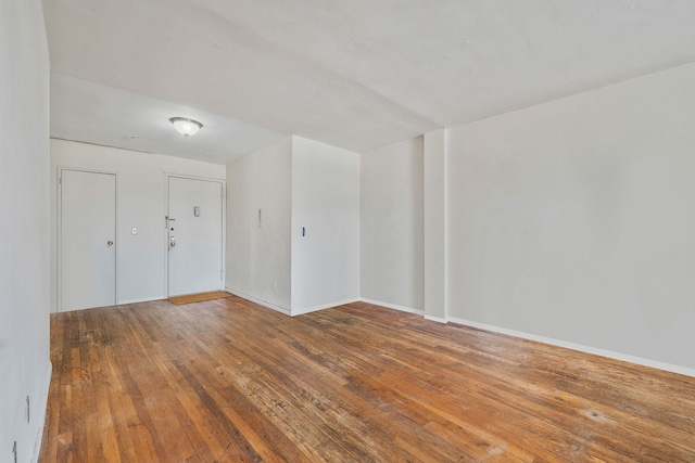 190 W Merrick Rd Unit 4E, Freeport, NY 11520 - empty room featuring wood-type flooring and baseboards