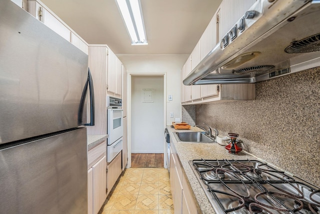 190 W Merrick Rd Unit 4E, Freeport, NY 11520 - kitchen featuring stainless steel appliances, exhaust hood, a warming drawer, and light countertops