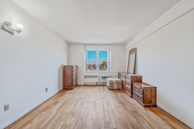 190 W Merrick Rd Unit 4E, Freeport, NY 11520 - sitting room featuring radiator heating unit and light wood-style flooring
