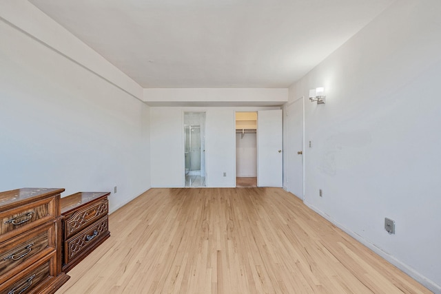 190 W Merrick Rd Unit 4E, Freeport, NY 11520 - unfurnished bedroom featuring hardwood / wood-style flooring and a spacious closet